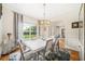 Stylish dining room with hardwood floors, modern chandelier, and large window, offering a bright and inviting space at 1420 Palmer Ave, Winter Park, FL 32789