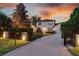 Charming two-story home with a well-manicured lawn, paved driveway, and inviting entrance at 1420 Palmer Ave, Winter Park, FL 32789