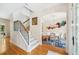 Bright foyer with hardwood floors, staircase, and an archway that leads to a dining area with stylish decor at 1420 Palmer Ave, Winter Park, FL 32789