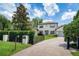 Charming two-story home featuring a gated entrance, well-manicured lawn, and beautiful landscaping at 1420 Palmer Ave, Winter Park, FL 32789