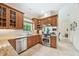 Well-equipped kitchen with stainless steel appliances, wooden cabinets, and granite countertops at 1420 Palmer Ave, Winter Park, FL 32789