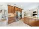 Spacious kitchen featuring stainless steel appliances, wood cabinetry, and a central island with granite countertops at 1420 Palmer Ave, Winter Park, FL 32789
