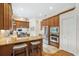 Gourmet kitchen with stainless steel appliances, granite countertops, and wood cabinetry with bar stool seating at 1420 Palmer Ave, Winter Park, FL 32789