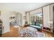 Cozy living room featuring hardwood floors, large window, and an archway leading to the formal dining room at 1420 Palmer Ave, Winter Park, FL 32789