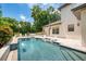 A sparkling pool with a waterfall feature and several seating options, great for entertaining guests at 1420 Palmer Ave, Winter Park, FL 32789