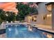 A gorgeous backyard pool with patio seating and lush landscaping, perfect for outdoor relaxation and entertaining at 1420 Palmer Ave, Winter Park, FL 32789