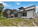 The backyard of this property features an outdoor kitchen, screened-in pool, and fire pit at 1429 Arbitus Cir, Oviedo, FL 32765