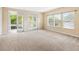 Spacious bedroom featuring large windows, double doors to the balcony, and neutral carpeting at 1429 Arbitus Cir, Oviedo, FL 32765