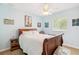 Light blue bedroom featuring a ceiling fan, and queen bed with white linens at 1429 Arbitus Cir, Oviedo, FL 32765