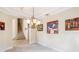 Formal dining room with elegant chandelier and staircase view at 1429 Arbitus Cir, Oviedo, FL 32765