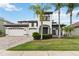 Beautiful two story home with 3 car garage and landscaped front yard with palm trees at 1429 Arbitus Cir, Oviedo, FL 32765