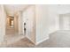 Neutral hallway showcasing a glimpse into the bedrooms and bathrooms, with carpeted floors at 1429 Arbitus Cir, Oviedo, FL 32765
