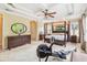 Large main bedroom with tray ceilings, fan, and a four-poster bed, showcasing a serene and spacious layout at 1429 Arbitus Cir, Oviedo, FL 32765