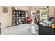 Cozy carpeted office with a large bookcase and natural light at 1429 Arbitus Cir, Oviedo, FL 32765