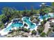 Aerial view of the resort's multiple pools, lush landscaping, and waterfront views with a pier and lake access at 14501 Grove Resort Ave # 2451, Winter Garden, FL 34787