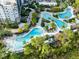 An aerial view shows the resort's multiple pools, lush landscaping, and ample seating for relaxation at 14501 Grove Resort Ave # 2451, Winter Garden, FL 34787