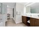 Elegant bathroom with double vanity, lighted mirror, and glass-enclosed shower for a spa-like experience at 14501 Grove Resort Ave # 2451, Winter Garden, FL 34787