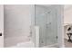 Modern bathroom with tiled shower, separate bathtub, and convenient storage shelving at 14501 Grove Resort Ave # 2451, Winter Garden, FL 34787