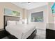 Cozy bedroom with a comfortable bed, side table, and a window for natural light at 14501 Grove Resort Ave # 2451, Winter Garden, FL 34787