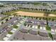 Wide aerial view of a sprawling residential neighborhood with manicured lawns and community amenities at 15096 Chapter Way, Winter Garden, FL 34787