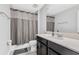 This bathroom features neutral walls, dark wood vanity with a light countertop, and a shower with a curtain at 15096 Chapter Way, Winter Garden, FL 34787