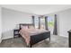 Cozy bedroom featuring a floral-patterned bedspread, windows, and carpeted floors at 15096 Chapter Way, Winter Garden, FL 34787