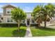 Charming two-story home with manicured lawn, mature trees, and inviting entrance at 15096 Chapter Way, Winter Garden, FL 34787