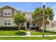 Charming two-story home featuring a well-maintained lawn and inviting landscaping, offering great curb appeal at 15096 Chapter Way, Winter Garden, FL 34787