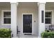 Close up of front door and facade. Large, bright windows illuminate address at 15096 Chapter Way, Winter Garden, FL 34787