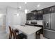 Modern kitchen featuring stainless steel appliances, a center island, and sleek cabinetry in an open layout at 15096 Chapter Way, Winter Garden, FL 34787