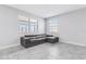 The living room is illuminated by natural light and filled with the comfort of an inviting leather couch at 15096 Chapter Way, Winter Garden, FL 34787