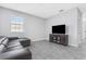 An open living room featuring tile flooring, a large window and a comfy couch at 15096 Chapter Way, Winter Garden, FL 34787