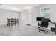 Open living area with tile flooring, neutral walls, and a dining area leading to an office space at 15096 Chapter Way, Winter Garden, FL 34787