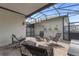 Screened patio with brick flooring and comfortable seating for outdoor relaxation and entertaining at 15096 Chapter Way, Winter Garden, FL 34787