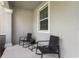Inviting front porch featuring two rocking chairs and a small table for a cozy outdoor space at 15096 Chapter Way, Winter Garden, FL 34787