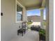 A view of the front porch with patio plants and bright light at 15096 Chapter Way, Winter Garden, FL 34787