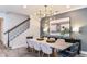 Elegant dining room boasts modern lighting, stylish decor, and seating for six at 16352 Crown Top Dr, Montverde, FL 34756