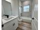 Bright bathroom with a tiled tub surround and updated vanity at 16463 Sw 55Th Court Rd, Ocala, FL 34473