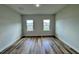 An empty bedroom with wood floors and a double hung window at 16463 Sw 55Th Court Rd, Ocala, FL 34473