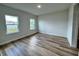 Well-lit bedroom featuring wood-look flooring and neutral walls at 16463 Sw 55Th Court Rd, Ocala, FL 34473