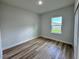 Bedroom featuring wood floors and a bright window for natural light at 16463 Sw 55Th Court Rd, Ocala, FL 34473