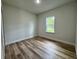 Bedroom featuring wood floors and a bright window at 16463 Sw 55Th Court Rd, Ocala, FL 34473