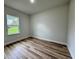 Bedroom featuring wood floors and a bright window at 16463 Sw 55Th Court Rd, Ocala, FL 34473