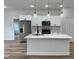 Modern kitchen featuring white cabinets, stainless steel appliances, and a center island at 16463 Sw 55Th Court Rd, Ocala, FL 34473