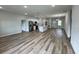 Bright, open-concept living space with wood-look floors and a modern kitchen island at 16463 Sw 55Th Court Rd, Ocala, FL 34473