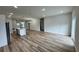 Bright, open-concept living space with wood-look floors and a modern kitchen island at 16463 Sw 55Th Court Rd, Ocala, FL 34473