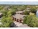 Aerial view of a residential neighborhood surrounded by lush greenery and mature trees at 173 Villa Di Este Ter # 209, Lake Mary, FL 32746
