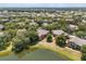 Scenic aerial view of condo buildings surrounded by lush greenery and a serene lake at 173 Villa Di Este Ter # 209, Lake Mary, FL 32746