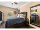 Bedroom with hardwood floors, ceiling fan, large mirror and TV on dresser at 173 Villa Di Este Ter # 209, Lake Mary, FL 32746