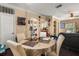 Open dining area with seating for four, dark floors, and adjacent kitchen and living spaces at 173 Villa Di Este Ter # 209, Lake Mary, FL 32746